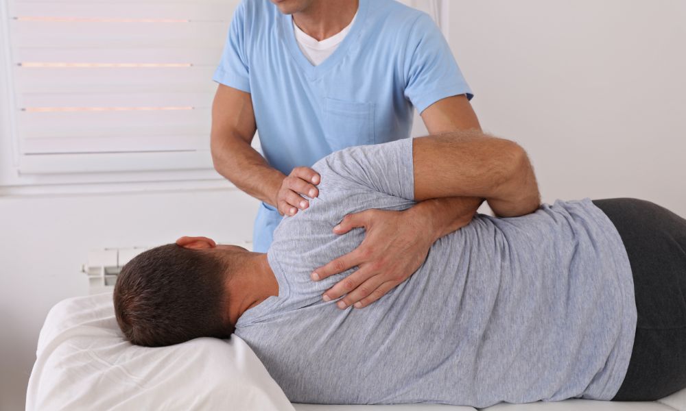 Professional chiropractor performing a gentle spinal adjustment